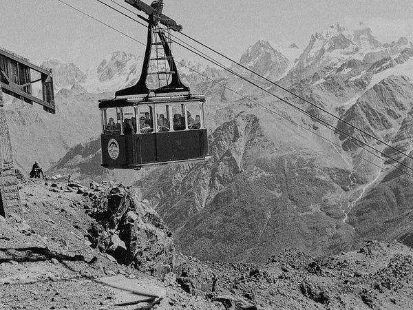 Vintage cable car against a mountainous landscape with Ilford Delta 400 Lightroom preset applied by PresetVault