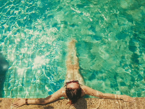 person floating in a turquoise pool with Fujifilm Fortia SP50 hyper-saturated vivid colours applied in Lightroom
